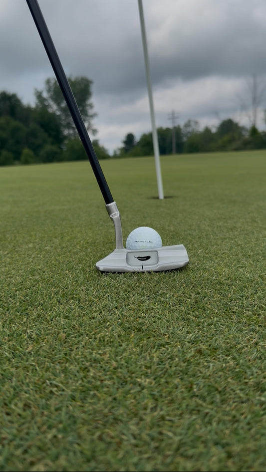 Kids Putter and Golf Ball with Pin in background
