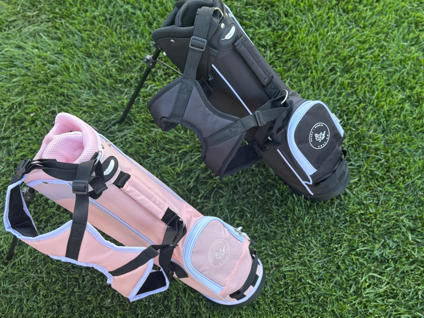 pink and black kids golf bags using stands on golf course