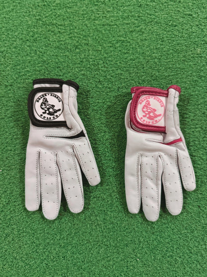 Two white golf gloves with brand logos on a green background
