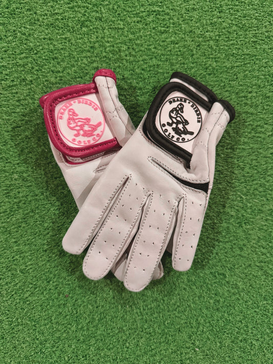 Pair of white gloves with red and black accents on a green background