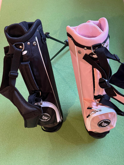 Black and pink kids' golf bag for toddlers ages 2-5 on a green